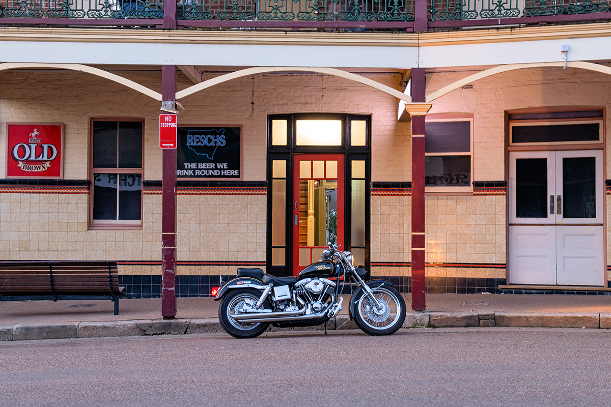 A Harley Davidson motorbike positioned at the front of the hotel